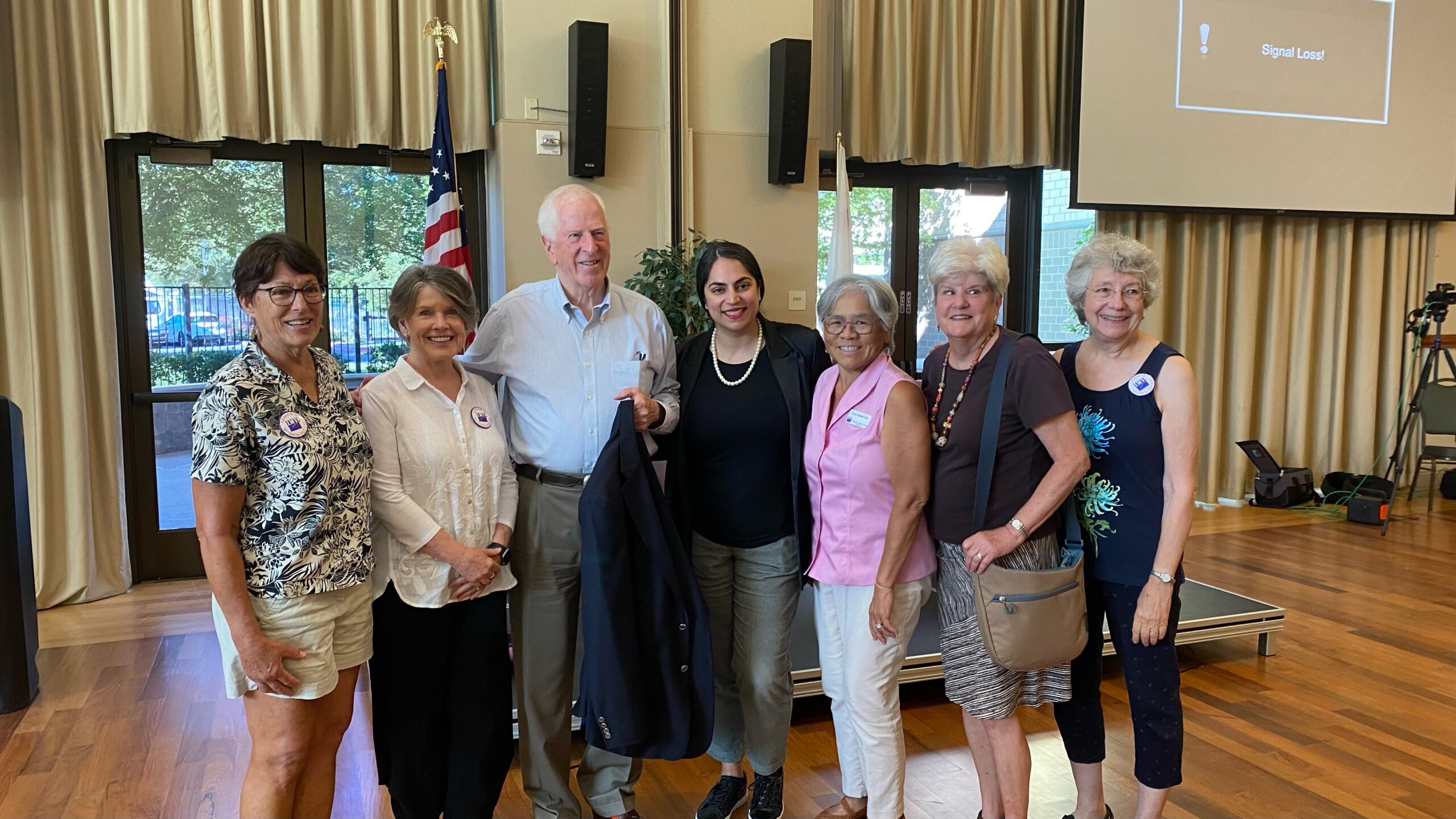 A group of LWV members are gathered with Rep Mike Thompson