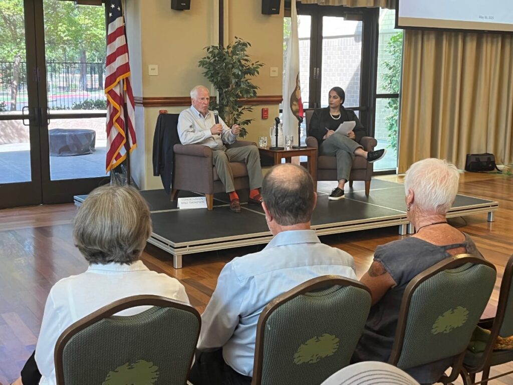 Congressman Mike Thompson and Co-Director of Communications, Kamal Hak on a low stage in front of audience