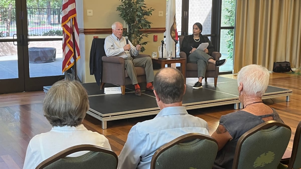 Congressman Mike Thompson and Co-Director of Communications, Kamal Hak on a low stage in front of audience