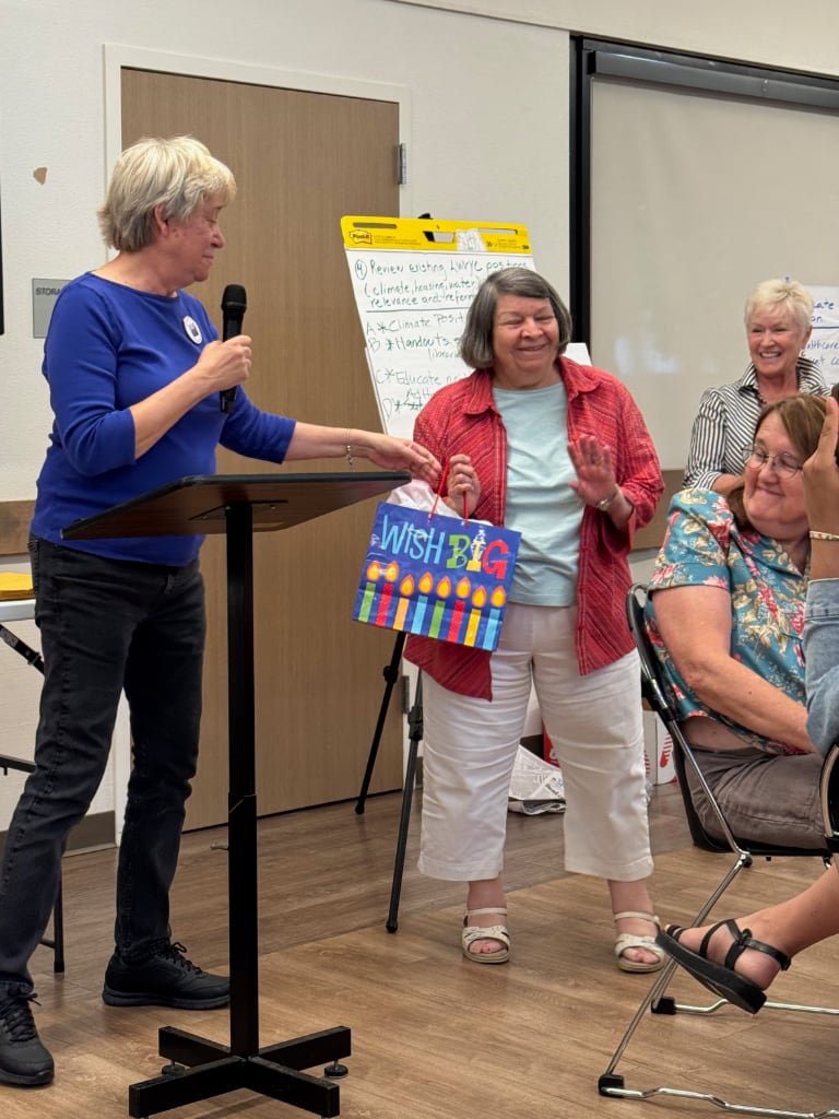Women handing out and receiving awards while others applaud at the Yolo County LWV Annual meeting.