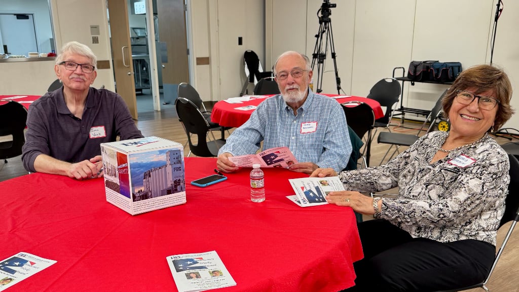Three active members of the local LWV sitting at a round table with red table cloth