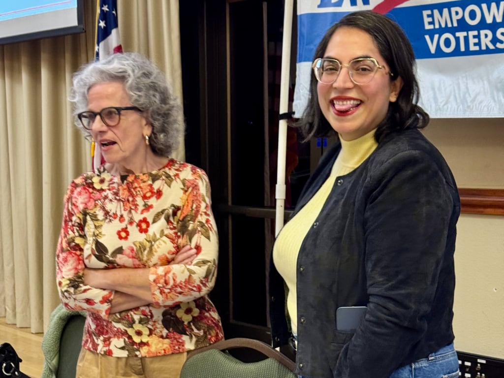 A dark-haired woman goofing around for the photographer