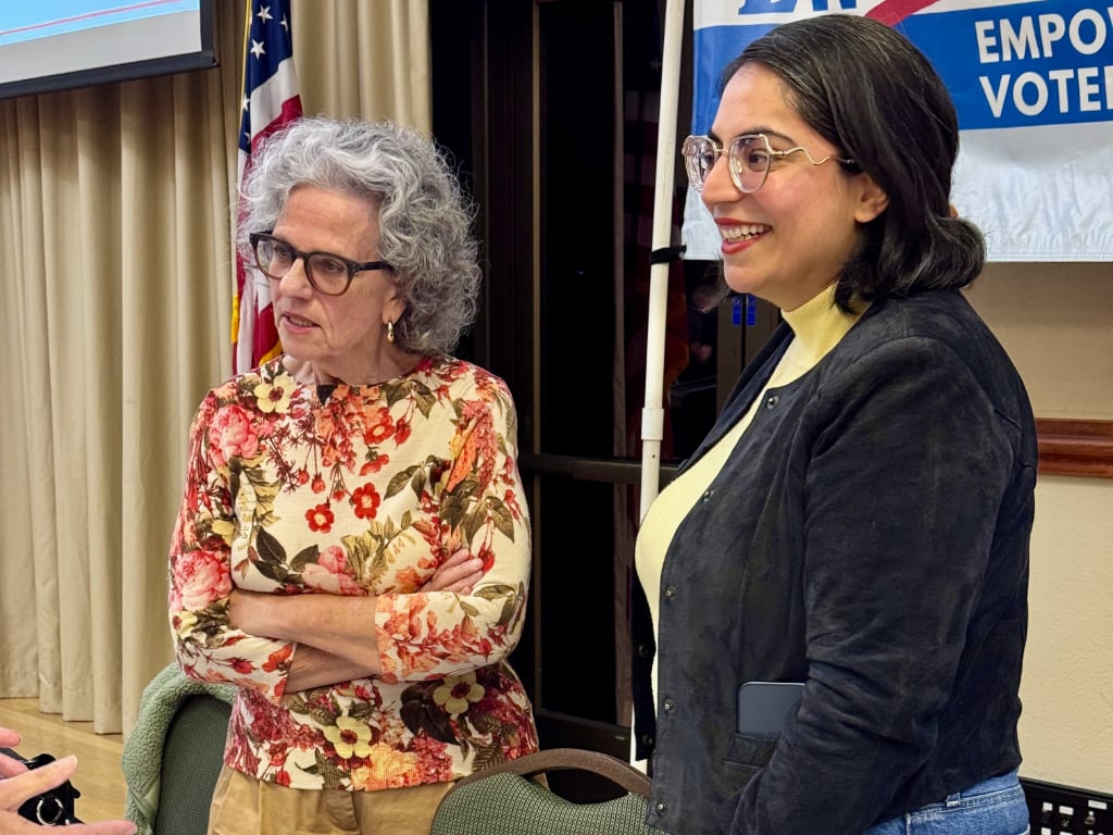 Two women talking to people off screen