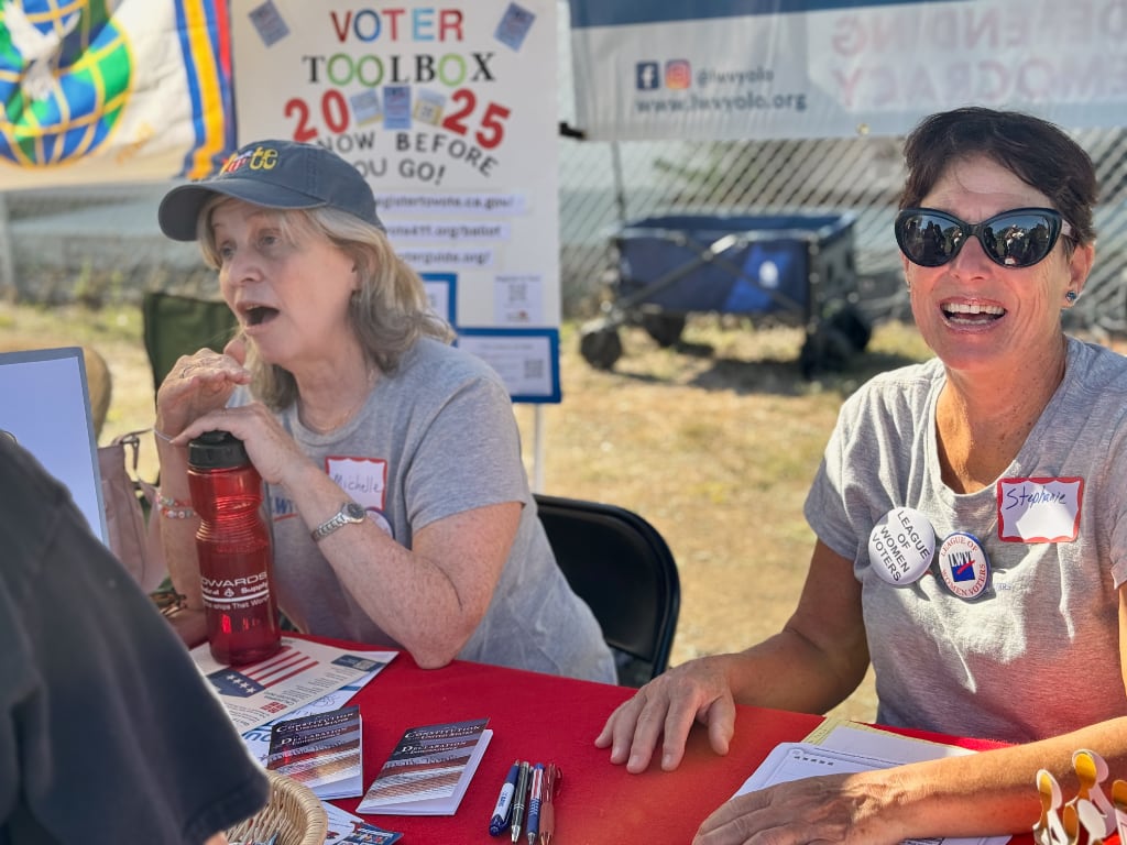 Close up of two women tabling at No Kings rally