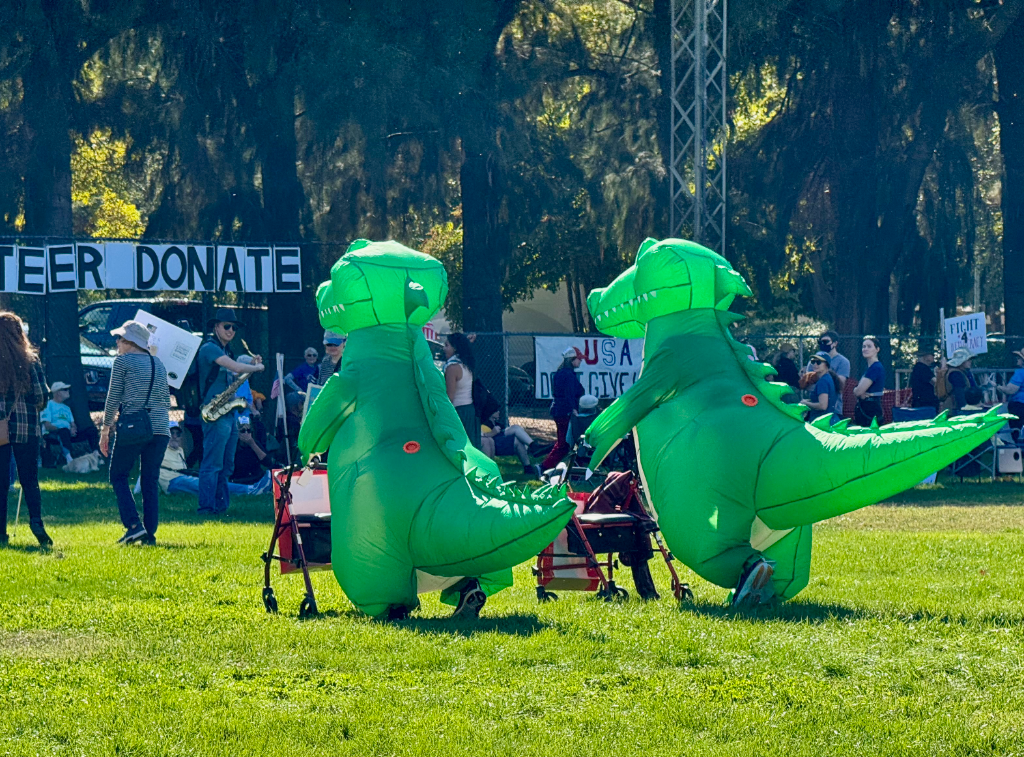 Two people in blow-up alligator costumes at No Kings rally