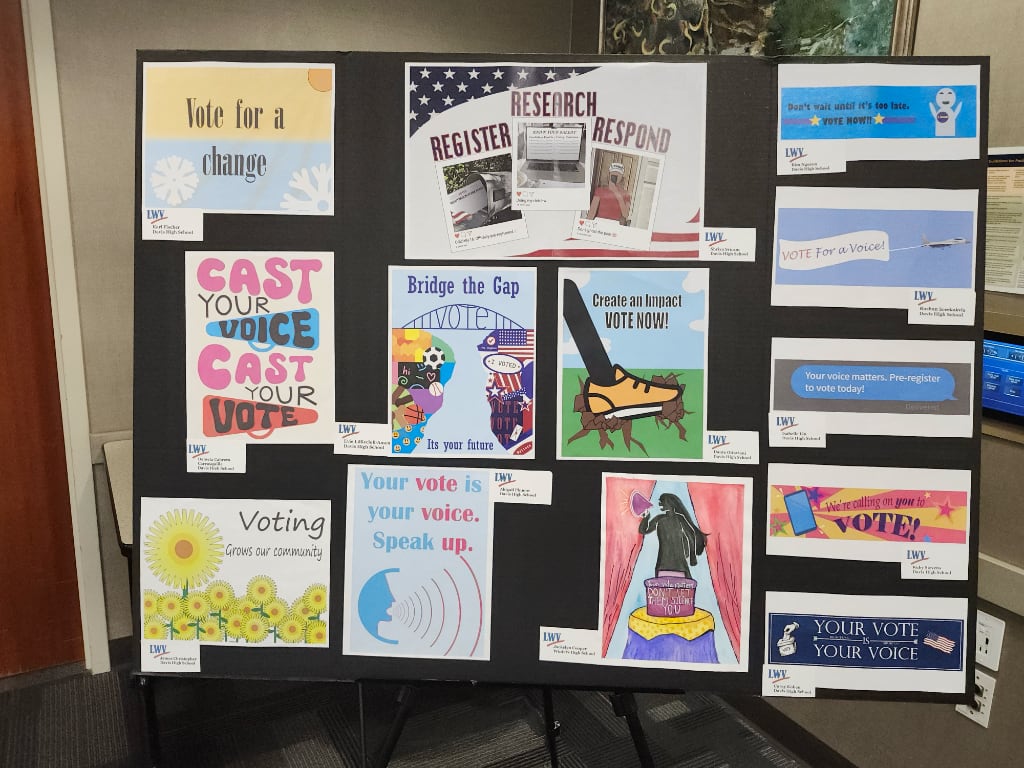A large poster board displaying Art Contest entries