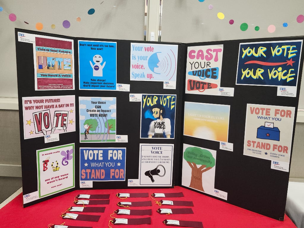 A large poster board displaying Art Contest entries