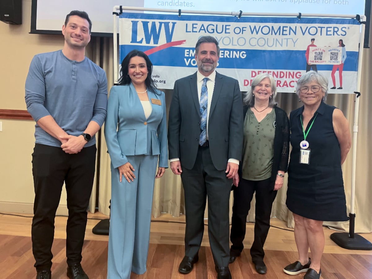 Two men and three women in front of a LWV of Yolo County banner